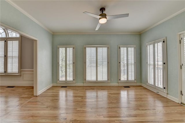 bathroom with tile patterned floors, a raised ceiling, a garden tub, and crown molding