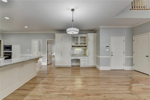 full bath with tile patterned floors, a stall shower, a tray ceiling, crown molding, and double vanity