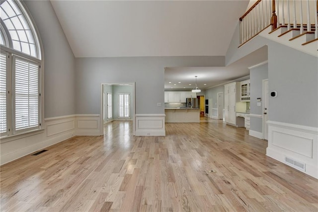 spare room with visible vents, baseboards, ceiling fan, and wood finished floors