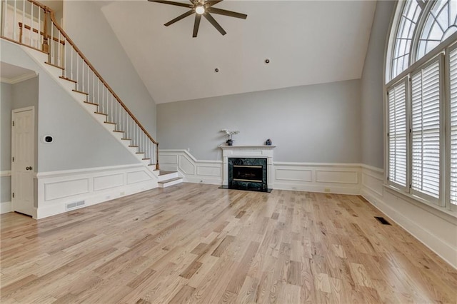 unfurnished room featuring visible vents, baseboards, wood finished floors, and a ceiling fan