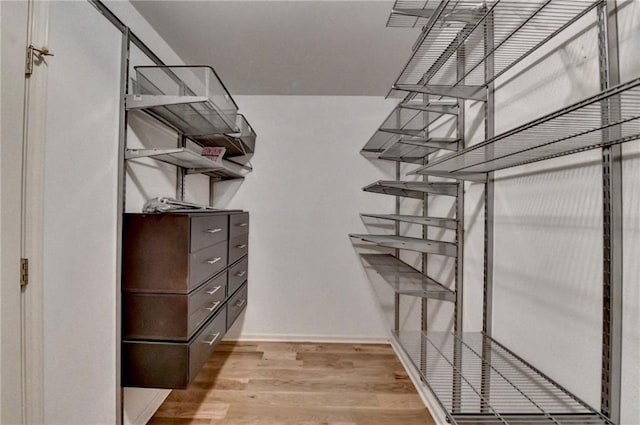 empty room with baseboards, visible vents, a ceiling fan, and light wood-style floors