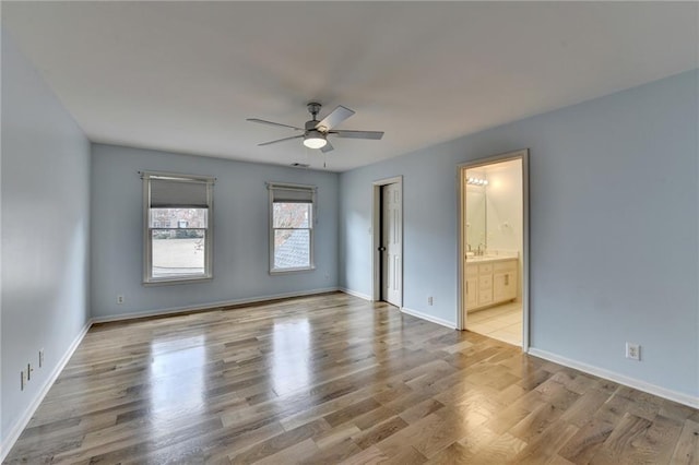 unfurnished living room with light wood-type flooring, high vaulted ceiling, a decorative wall, a premium fireplace, and stairs