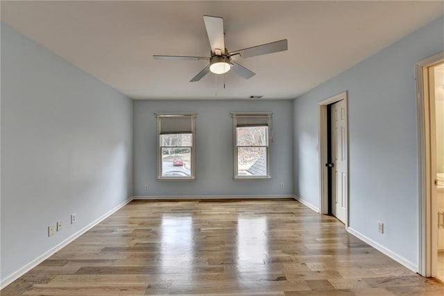 carpeted spare room featuring ceiling fan, visible vents, baseboards, and ornamental molding