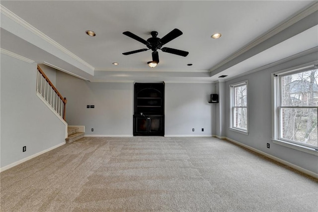 unfurnished living room with visible vents, a high ceiling, stairs, and a ceiling fan