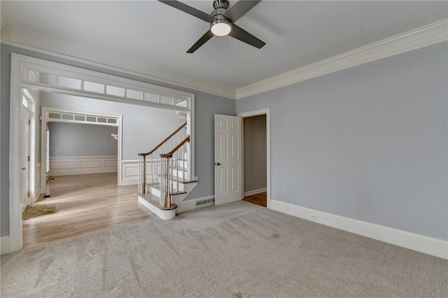 entrance foyer with visible vents, a healthy amount of sunlight, wood finished floors, and stairs