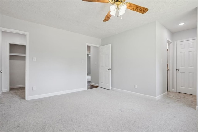 12 Windsor Way, Newnan, GA 30263 - unfurnished bedroom featuring carpet floors, a textured ceiling, a spacious closet, a ceiling fan, and a closet