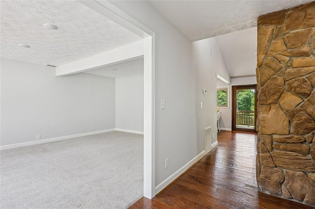 12 Windsor Way, Newnan, GA 30263 - hallway featuring a textured ceiling, wood finished floors, and lofted ceiling