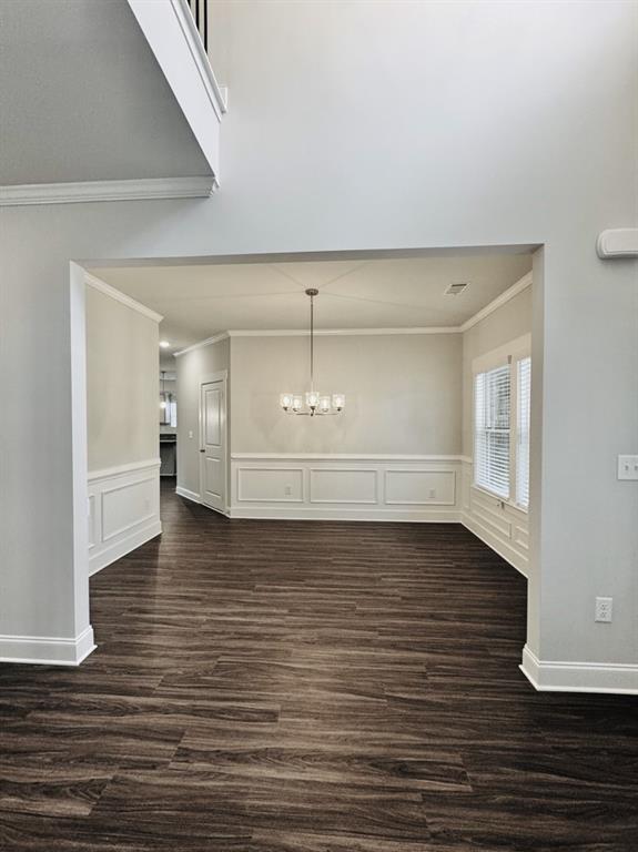 61 Observation Way, Dallas, GA 30132 - interior space with wainscoting, an inviting chandelier, ornamental molding, and dark wood-style flooring