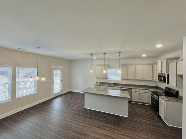 61 Observation Way, Dallas, GA 30132 - kitchen with baseboards, appliances with stainless steel finishes, dark wood finished floors, and a center island