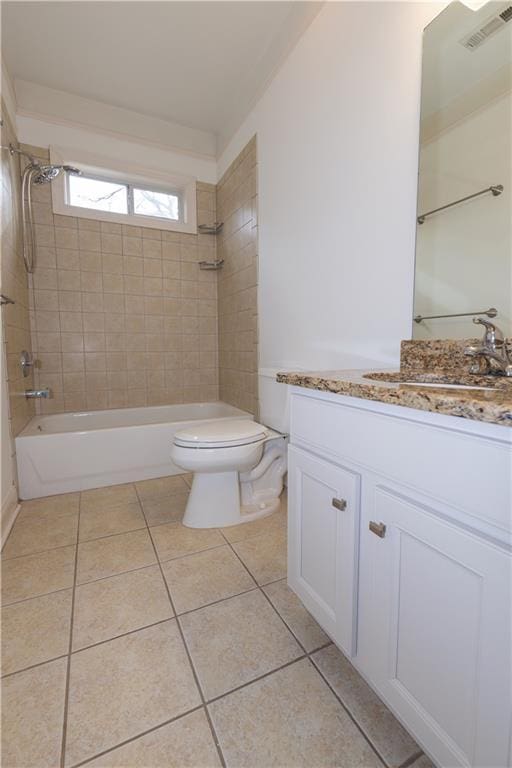 full bathroom featuring tiled shower / bath combo, vanity, tile patterned flooring, and toilet