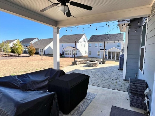 view of patio with ceiling fan and a fire pit