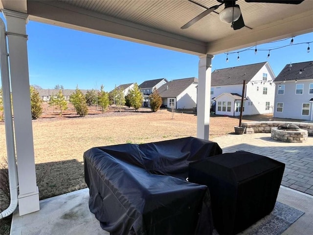 view of patio / terrace featuring ceiling fan and an outdoor fire pit