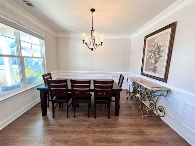 dining area featuring an inviting chandelier, crown molding, and dark wood-type flooring