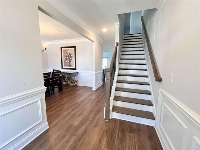 stairs featuring hardwood / wood-style flooring and crown molding