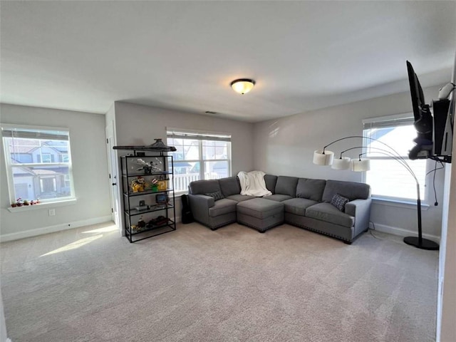 living room with light colored carpet and plenty of natural light