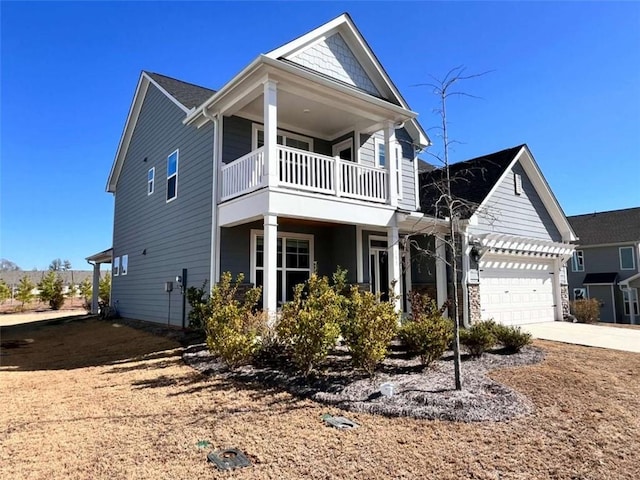 view of front of property featuring a garage and a balcony