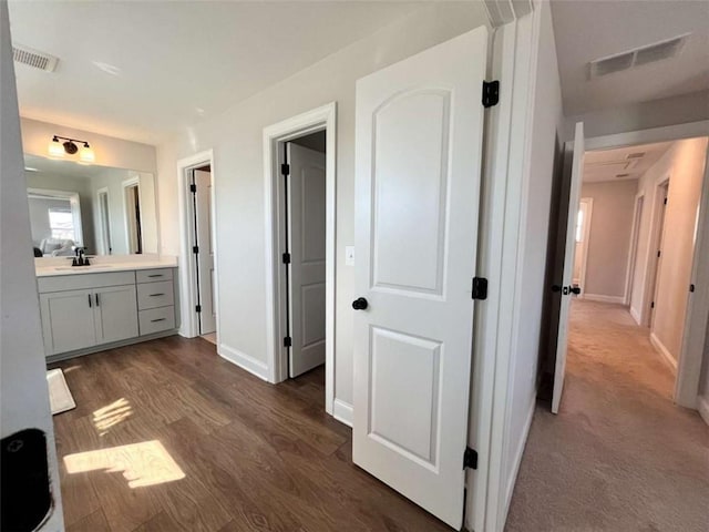 hallway featuring dark hardwood / wood-style flooring and sink