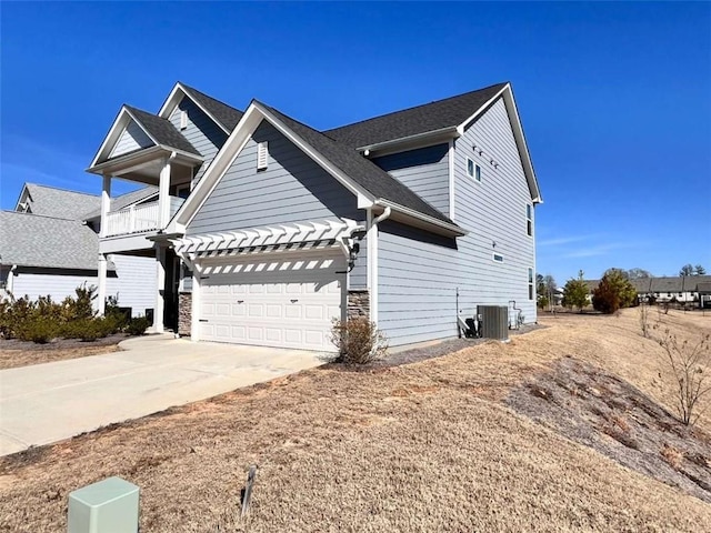 view of front of home with a balcony and central AC unit