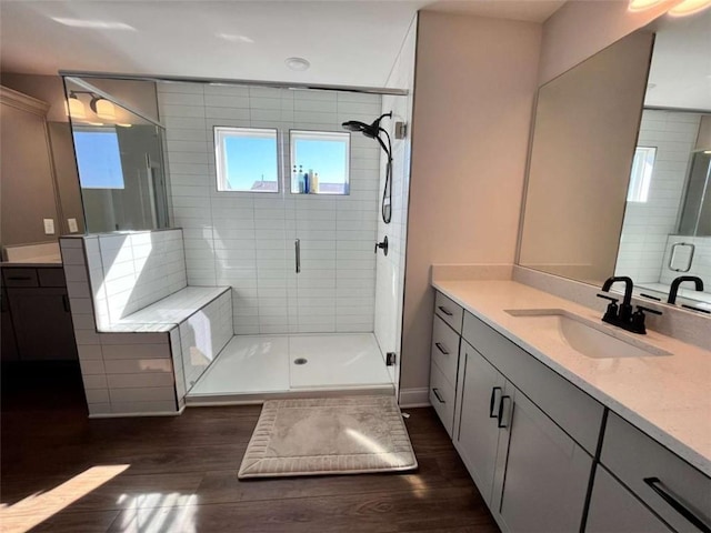 bathroom featuring an enclosed shower, vanity, and hardwood / wood-style flooring