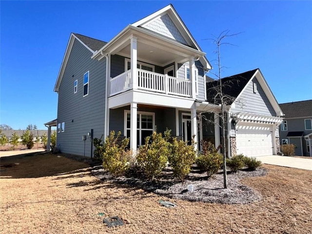 view of front of house with a garage and a balcony