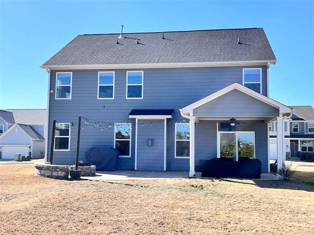 rear view of property featuring ceiling fan and a patio