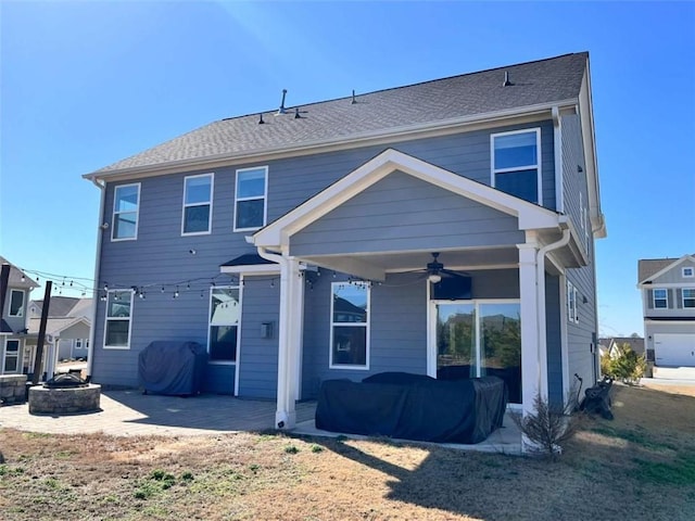 rear view of property featuring ceiling fan, an outdoor fire pit, and a patio