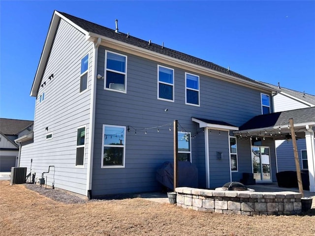 back of house with cooling unit, an outdoor fire pit, and a patio area