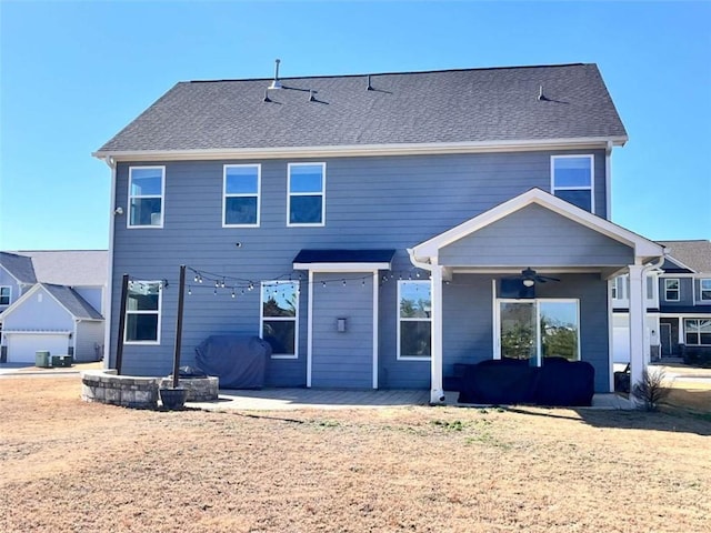 rear view of property with a patio and ceiling fan