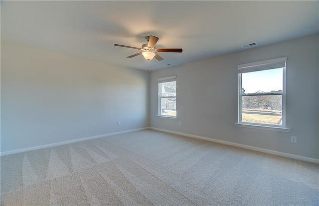 unfurnished room with ceiling fan and light colored carpet