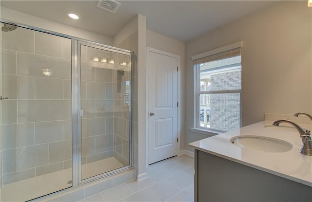 bathroom with vanity, tile patterned flooring, and a shower with door