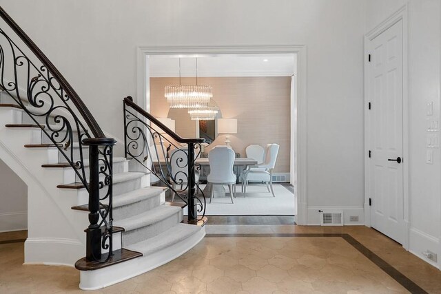 entryway featuring an inviting chandelier