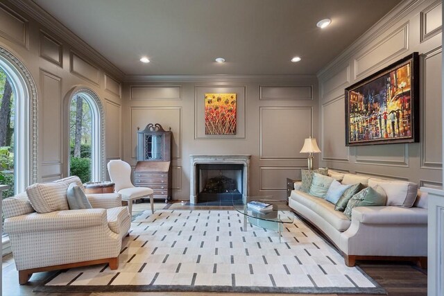 sitting room featuring ornamental molding and light wood-type flooring