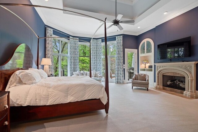 carpeted bedroom with access to exterior, ceiling fan, and ornamental molding