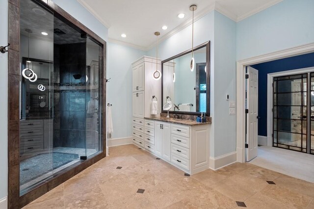 bathroom with vanity, crown molding, and walk in shower