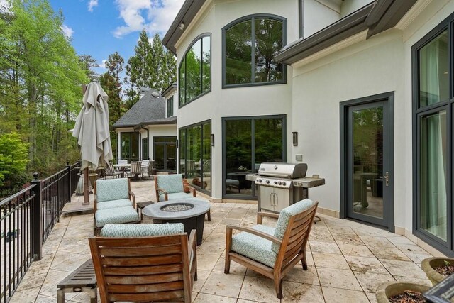 view of patio / terrace with grilling area and an outdoor fire pit