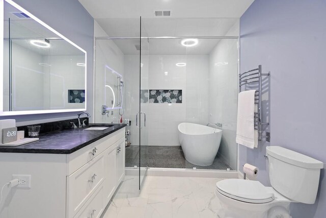 bathroom with radiator, vanity, a shower with shower door, and toilet