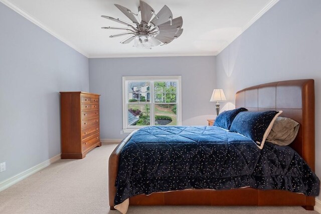 bedroom with ceiling fan, carpet floors, and crown molding