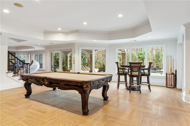 game room with a raised ceiling, crown molding, billiards, and light parquet flooring