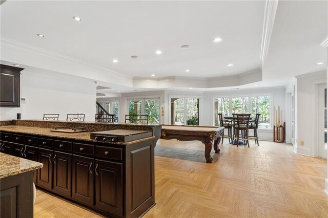 kitchen featuring crown molding, dark stone countertops, and billiards