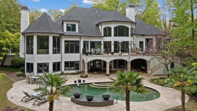 back of property with a patio area and a balcony