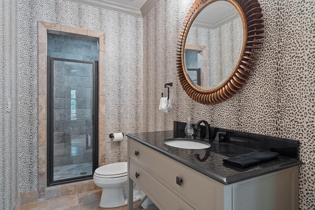 bathroom featuring crown molding, a shower with door, vanity, and toilet