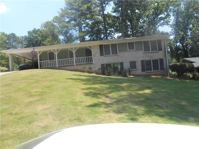 view of front of property featuring a carport and a front lawn