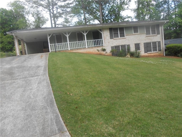 view of front of home with a front yard and a carport