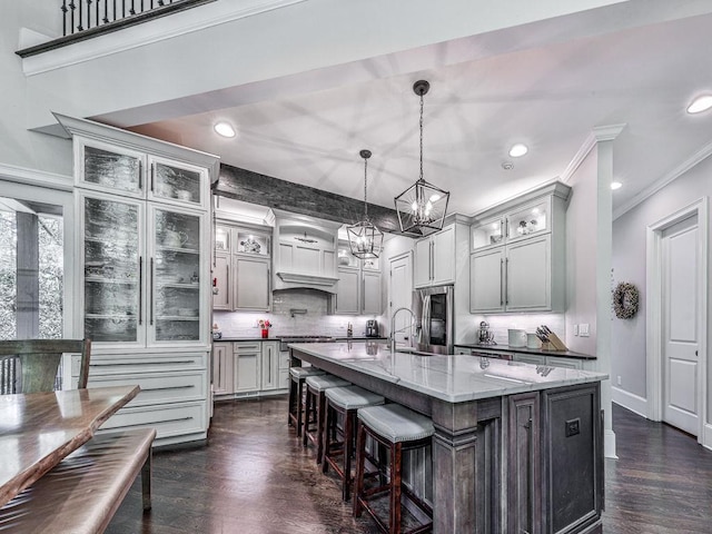 5039 Towne Lake Hls N, Woodstock, GA 30189 - kitchen with stainless steel fridge with ice dispenser, a chandelier, decorative backsplash, dark wood-style flooring, and ornamental molding