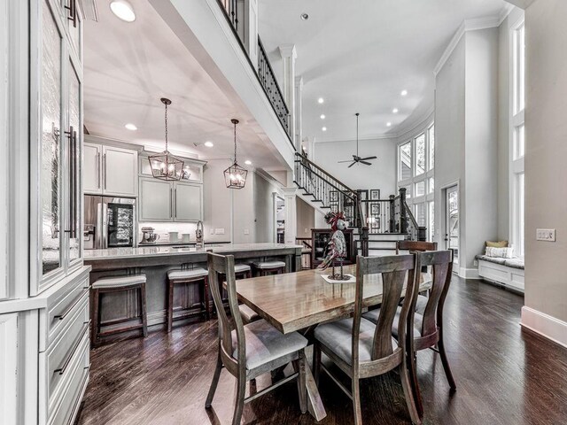 5039 Towne Lake Hls N, Woodstock, GA 30189 - dining area with stairway, recessed lighting, dark wood-style floors, ornamental molding, and baseboards