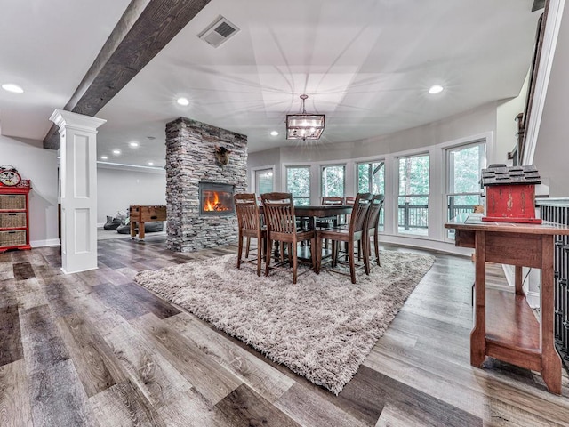 5039 Towne Lake Hls N, Woodstock, GA 30189 - dining area featuring a fireplace, wood finished floors, recessed lighting, baseboards, and ornate columns