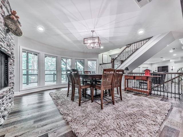 5039 Towne Lake Hls N, Woodstock, GA 30189 - dining area featuring healthy amount of natural light, a chandelier, stairway, wood finished floors, and recessed lighting