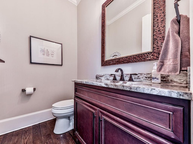 5039 Towne Lake Hls N, Woodstock, GA 30189 - bathroom featuring ornamental molding, baseboards, toilet, wood finished floors, and vanity