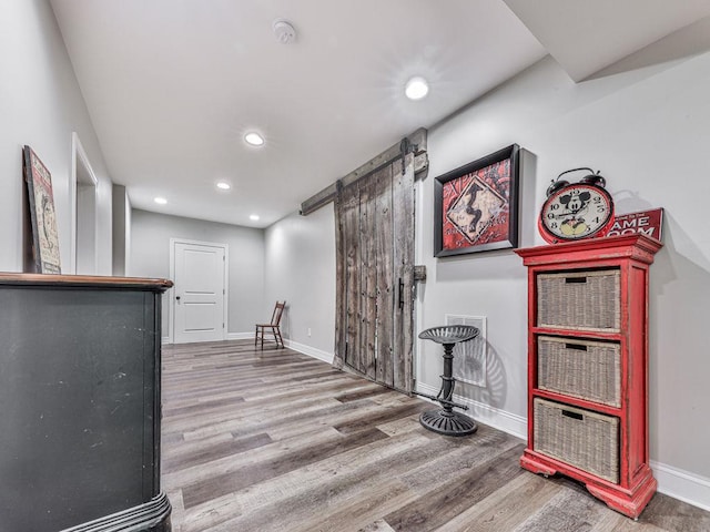 5039 Towne Lake Hls N, Woodstock, GA 30189 - bar area with a barn door, wood finished floors, baseboards, and recessed lighting
