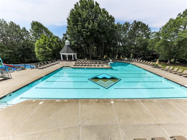 5039 Towne Lake Hls N, Woodstock, GA 30189 - community pool with a gazebo, a patio area, and view of wooded area